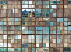seamless background, windows of an old decrepit factory with rusty frames and dirty glass, blue sky reflection