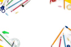 Back to School. Frame of school supplies ( pencil, scissors, sharpener, clips, crayons ) on a white background with space for text. Top view, flat lay