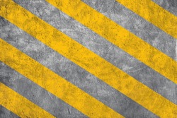 Top view of Yellow caution warning lines on concrete floor grunge texture background.