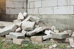  Pile of rocks, concrete blocks and sand against  Construction waste, concrete debris from the demolition.