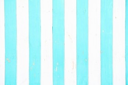 in the foreground there are white and turquoise stripes made of wood                         