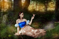 Fairy tale princess with poisoned apple in the magic wood 