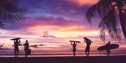 Silhouette of surfer people carrying their surfboards on sunset beach. Panoramic soft style with vintage filter effect for banner background. 
