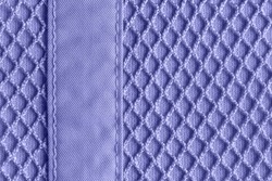 Background of textile mesh over cotton jersey. Macro. Texture of blue violet knitted fabric with mesh for outerwear casual clothing. Modern sportswear in in trendy color 2022 very peri. Copy space.