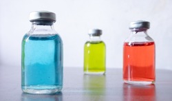 The three colored solution containing vials.