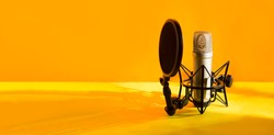 Professional microphone with waveform on yellow background banner. Podcast or recording studio background