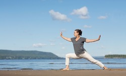 Woman praticing tai chi chuan on the beach. Chinese management skill Qi's energy. solo outdoor activities. Social Distancing 
