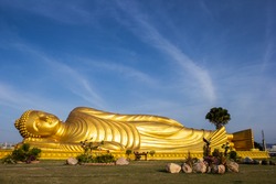 Reclining Buddha gold statue face at Bangkok, Thailand