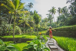 Beautiful girl visiting the Bali rice fields in tegalalang, ubud. Concept about people, wanderlust traveling and tourism lifestyle