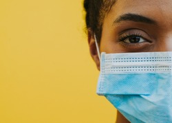 African american woman wearing medical mask against corona virus