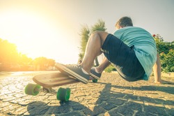 Man riding on a longboard at the sunset