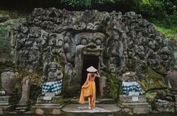 Beautiful girl visiting the goa gajah temple in ubud , Bali. Concept about wanderlust traveling