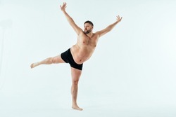 Man posing for a male edition body positive beauty set. Shirtless guy wearing boxers underwear in studio