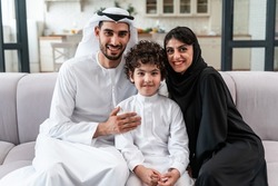 happy family spending time together. Arabian parents and their son playing and making different activities at home