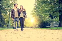 Couple walking hand in hand in a park - Romantic date outdoors