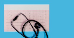 ECG 12 lead Cardiogram with stethoscope on  blue background, panorama