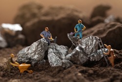 Mining of Tantalum, Nickel, Cobalt, lithium. Miniature worker mining metal Tantalum and silver. Mining business, Mineral Resources.