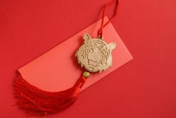 Chinese New Year 2022 decoration Gold Tiger, Red Envelope on red background. copy space