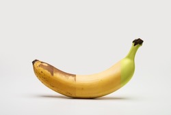 Ripening stages of a banana on a white background with a soft shadow.