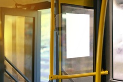 Open bus door entrance with yellow handrail and copy space empty poster on a window. Infrastructure. Door. No People. Waiting. Inside. Mock. Ride. System. Seat. Frame. Copy space