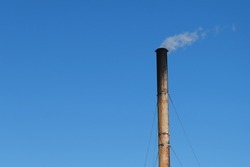 A sooty, soot-covered pipe of a coal boiler house. Energy production using coal is harmful to the environment.