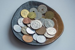 Korean won Japanese yen coins,  collectible coin,  empire, collectors, numismatic, metal money,  tokens collection of currency, on metal tray, on bazaar antique shop financal economy
