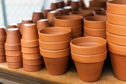Stacked red clay pots for planting at sale in a garden center