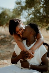 Love story. Pair photo session with a beautiful couple man and woman. Passion, love, kiss. Nature, summer, park, Greece, Crete, olive grove