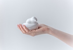 white bubbled foam in hands, hair foam, foam for man, white textured, hand full of soap isolated on white background