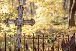an unnamed burial cross in an abandoned cemetery, old cemetery, grave with a vintage cross, fall season
