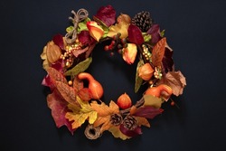 autumn wreath of fruits and leaves on black, cozy autumn design, thanksgiving background, autumn welcome concept