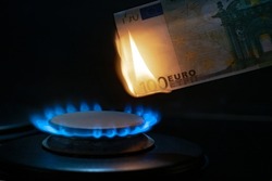 100 euro banknote on a gas burner. The concept of cost for natural gas. Energy crisis. High cost, gas price. Sanctions