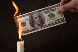 inflation concept, US dollar burns in fire, price increase, currency depreciation