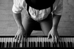 Talent and virtuosity. Black and white top view image of man playing piano