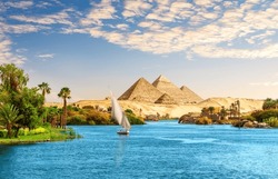 Beautiful Nile scenery  with sailboat in the Nile on the way to pyramids, Aswan, Egypt