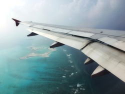 Atoll at Maldives tropical beach with blue sea from airplane view by soft focus.