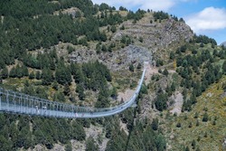 Canillo, Andorra. 2022 June 9. People walking on the longest Tibetan bridge in Europe, 600 meters long and 200 meters high in the Parish of Canillo in Andorra.