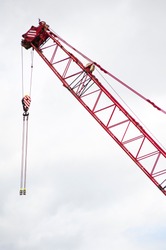 closeup of the top of a crane boom with the steel cables and pulley
