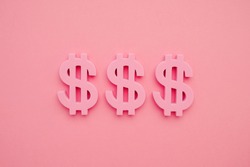 American dollar symbol on pink background, minimal flatlay