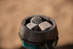 Coals for hookah close-up. Burning coals on the hookah bowl.