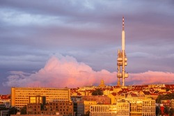 A pink cloud behind the Zizkov TV tower in Prague in sunset.