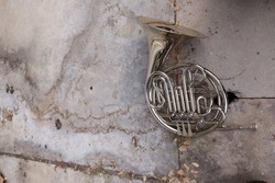 Old vintage rusty French horn on the floor, selectable focus top view