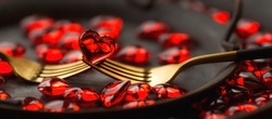 Banner. Festive table setting.Heart on a fork close-up. Holiday concept. Valentine's Day. Copy space for inscriptions.