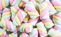 Marshmallows. Chewy candy close-up on a turquoise background. The dessert of sweet food. Pastel colors. Copy of the text space.