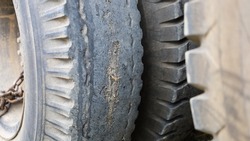 Damaged car tires. Close-up of a worn or torn car tire of a large truck tire. Selective focus
