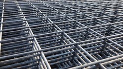 Steel wire mesh pile. BRC welded wire mesh for slab construction in natural light top view. Selective focus