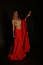 Beautiful beauty and fashion model in red traditional Indian costume 