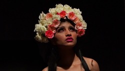 Portrait of beautiful celebrity fashion and beauty model from Bollywood using flowers as natural element.