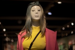 Mannequin girl. Fashion show on mannequin. Figure of man in store. Hairstyle with green tint. Yellow T-shirt.