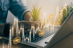 Casual Businessman Hand Hold Office Plants with Slant Number Value, Stock Bar Chart and Line Graph. Business Growth and Financial Stock Market Concept in Vintage Tone